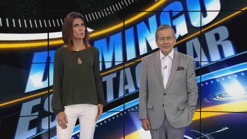Janine Borba e Paulo Henrique Amorim no cenário virtual do Domingo Espetacular