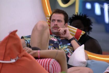 Gustavo sentado na área externa do BBB 22.