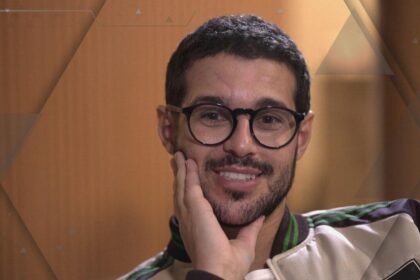 Rodrigo Mussi com a mão no pescoço, em trecho de entrevista para o fantástico