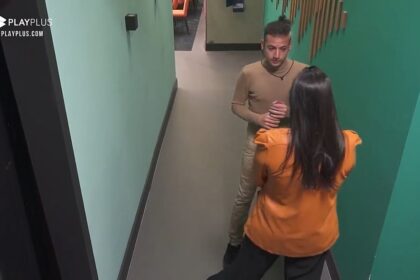 Gabi de costas na imagem de frente para Cartolouco no corredor da Mansão Power.