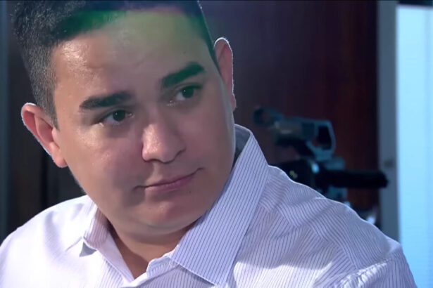 Allan Jesus em perfil diagonal durante entrevista com Roberto Cabrini para o Câmera Record, da Record TV