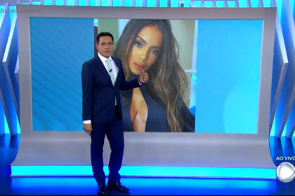 Willian leite nos estúdios do balanço geral, em frente ao telão mostrando a imagem de anitta