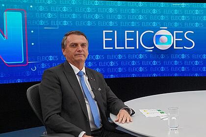 Jair Bolsonaro sorrindo na bancada do Jornal Nacional da TV Globo