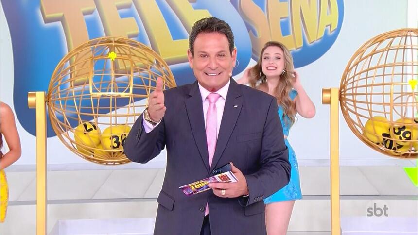Luiz Ricardo sorrindo no cenário do programa Tele Sena