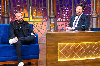 Ítalo sena sentado no sofá azul, em frente a danilo gentili em trecho da entrevista o the noite