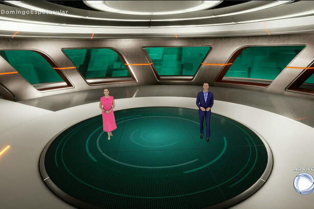Caroline Ferraz de vestido rosa e Sérgio Aguiar de terno azul em novo cenário do Domingo Espetacular