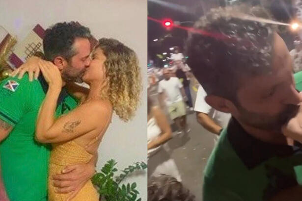 Barbara Borges e Iran Malfitano trocando beijos em frente à uma árvore de natal
