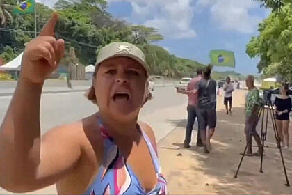 Mulher levanta o dedo para agredir repórter da Record TV em Recife