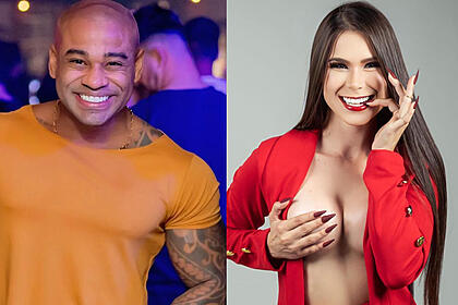 Cezar Black de camisa laranja, sorrindo, durante curtição em balada de Salvador; Maizy Magalhães, de blazer vermelho aberto, segurando 1 peito com a mão direita e com o dedo na boca com a mão esquerda durante ensaio fotográfico