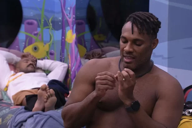 Fred Nicácio sem camisa sentado na cama do Quarto Fundo do Mar