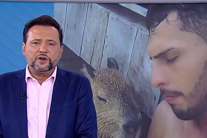 Geraldo Luís apresentando o Balanço Geral SP ao lado do telão que mostra imagens da Capivara Filó e seu tutor Agenor Tupinambá