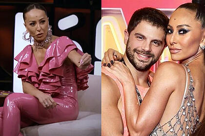 Imagem 1: Sabrina Sato de camisa e calça rosa, sentada, apontando pro convidado em seu programa no GNT