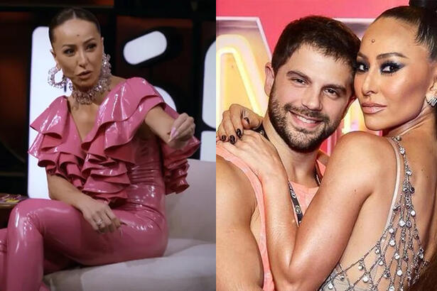 Imagem 1: Sabrina Sato de camisa e calça rosa, sentada, apontando pro convidado em seu programa no GNT