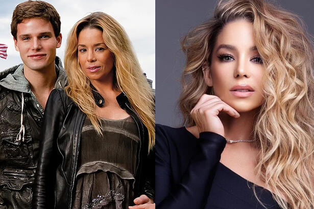 Imagem 1: Danielle Winits de casado e vestido preto, cabelo solto, abraçada por traz por Jõnatas Faro