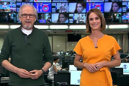 Nélson Araújo de camisa verde e Helen Martins de vestido laranja apresentando o Globo Rural