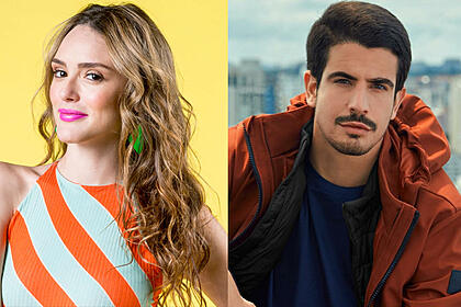 Imagem 1: Isabelle Drummond com camisa laranja listrada com branco, cabelo loiro, solto, usando brinco verde durante ensaio fotográfico; Imagem 2: Enzo Celulari com sobretudo marrom, camisa azul escura, com semblante sério, durante ensaio fotográfico