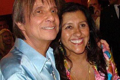 Roberto Carlos de camisa social azul, sorrindo, abraçado com Regina Casé