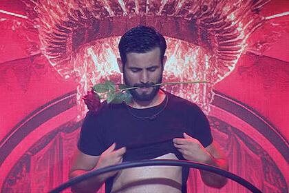 Matteus com uma rosa na boca e sensualizando na festa do BBB