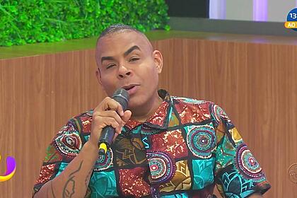Alex Lopes segura o microfone enquanto apresenta o programa Universo na TV Aratu
