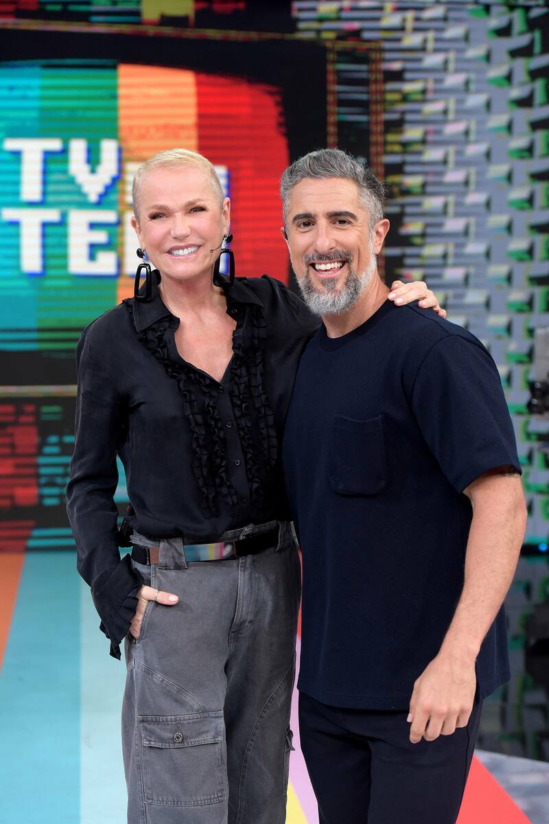 Xuxa sorrindo ao lado de Marcos Mion