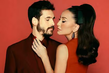 Sabrina Sato abraça Nicolas Prattes. Os dois vestem vermelho