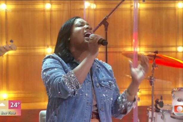 Sued Silva com as mãos levantadas ministrando e cantando no Encontro