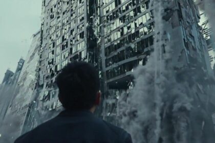 Homem olha para um prédio desabando em cena do filme alerta vermelho