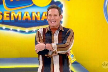 Luis Ricardo com os braços cruzados e sorrindo no cenário da Tele Sena Semanal edição 54