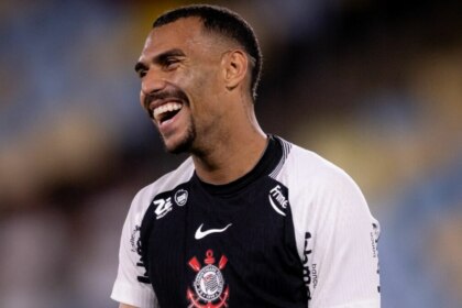 Matheuzinho, sorridente, comemorando gol com a camisa do Corinthians no jogo contra o Fluminense