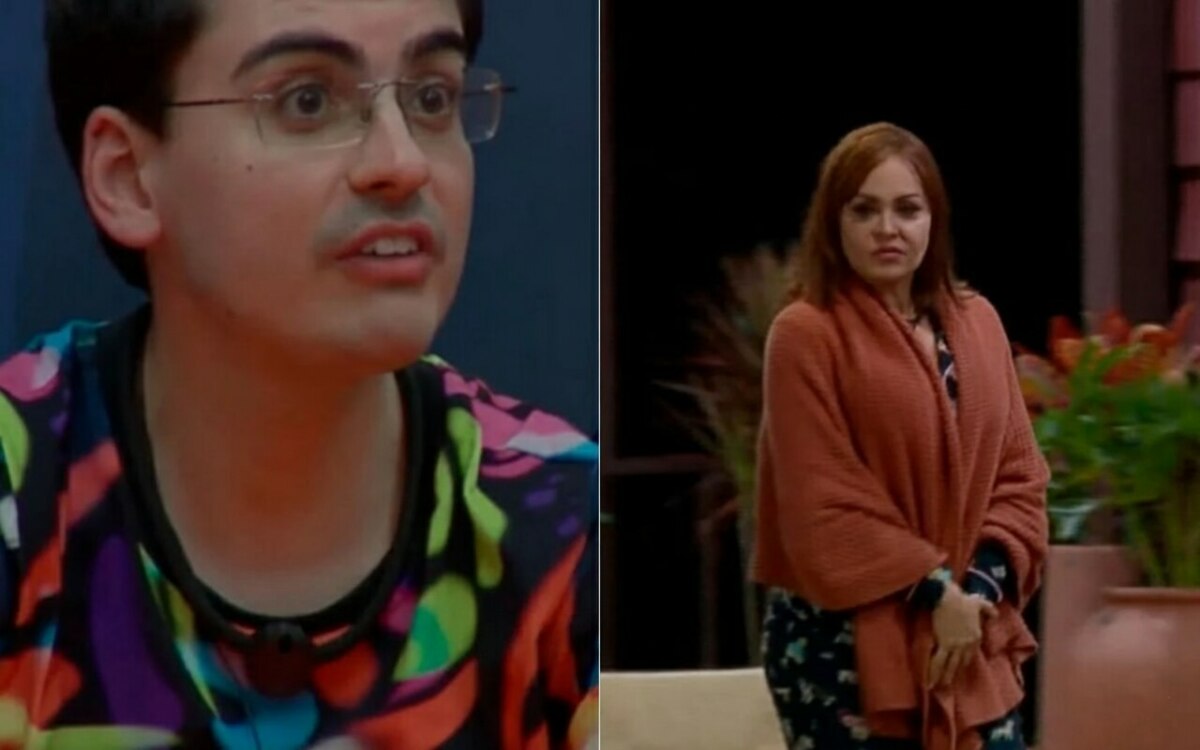 Dudu Camargo sentado na área interna de A Fazenda 17 e Gabriela Spanic andando na entrada da sede