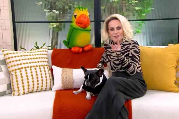 Ana Maria Braga ao lado do Louro Mané e de um cachorrinho, sentados no sofá do cenário do Mais Você