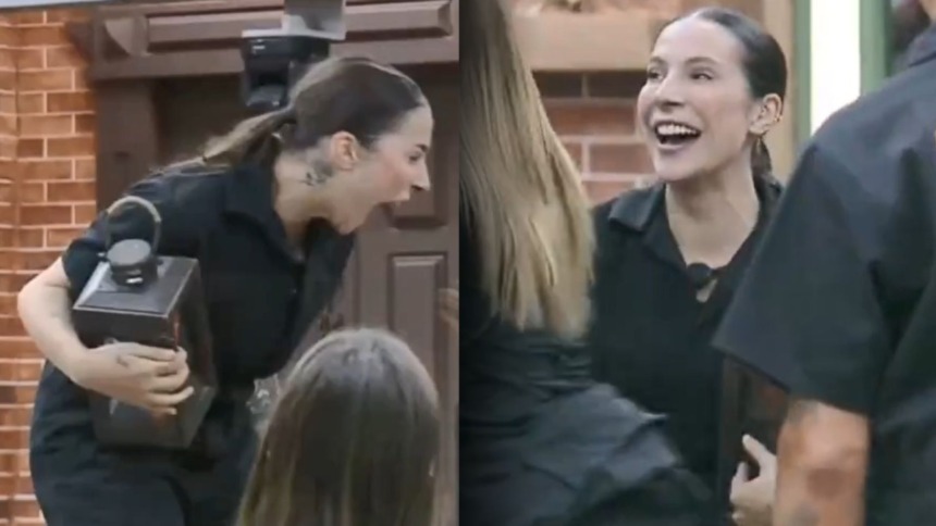 Martina com o lampeão na mão celebrando a vitória na Prova de Fogo na sala de A Fazenda
