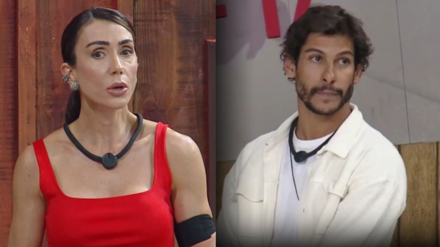 Montagem de Michelle Barros (vestido vermelho, com colar preto no pescoço) com uma expressão séria e do participante Shia (camisa branca, jaqueta bege) olhando para o lado, ambos nos estúdios do reality show A Fazenda.