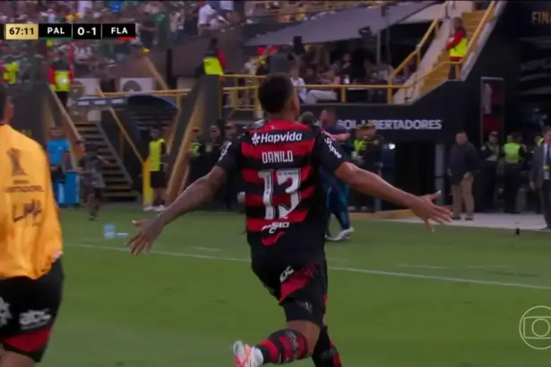 Danilo corre no meio do campo com os braços abertos comemorando o Gol da vitória do Flamengo na Libertadores