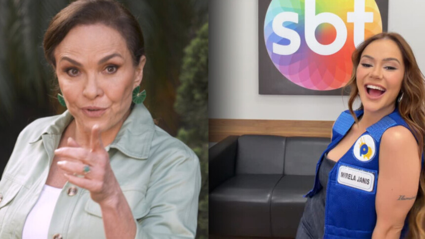 Luíza Tomé aponta o dedo para a câmera enquanto Mirela Janis sorrir no camarim do SBT. Ela veste colete azul