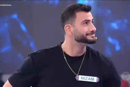 Nizam olha para o lado e sorrir após perder dinheiro no palco do Acerte ou Caia!