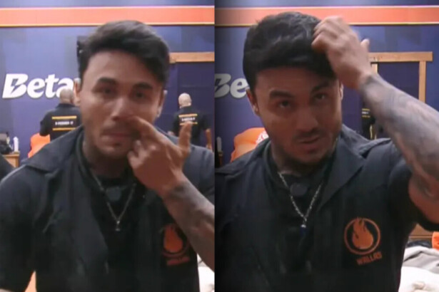 Wallas com o dedo dentro do nariz e passando a mão no cabelo