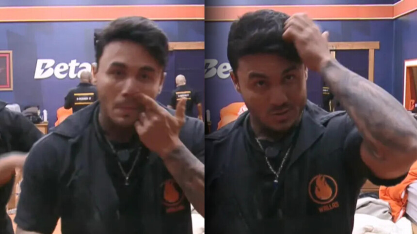 Wallas com o dedo dentro do nariz e passando a mão no cabelo