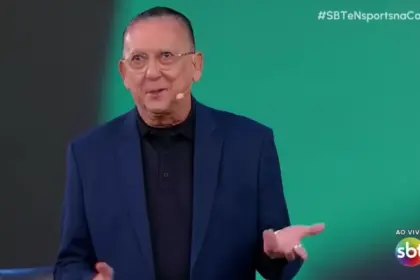 Galvão Bueno sorrindo no cenário do sorteio da Copa do Mundo no SBT