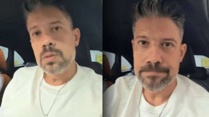 Jornalista Phelipe Siani em vídeo selfie dentro do carro, com expressão séria, relatando o assalto e a quebra do vidro do veículo