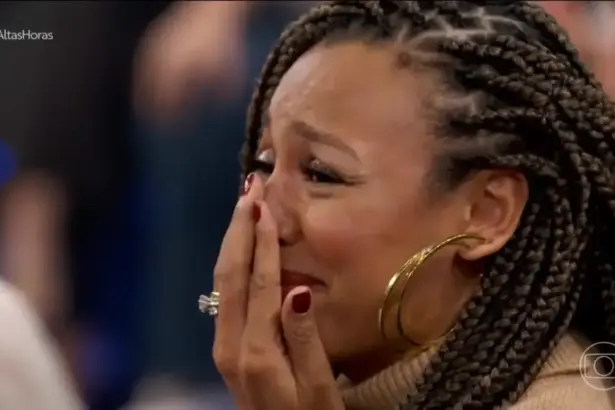 Sheron Menezzes chorando com a mão na boca no palco do Altas Horas ao ver o cantor Djavan