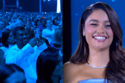 Xamã segura um celular, sorrir, e filma Sophie Carlotte no palco do Especial Roberto Carlos