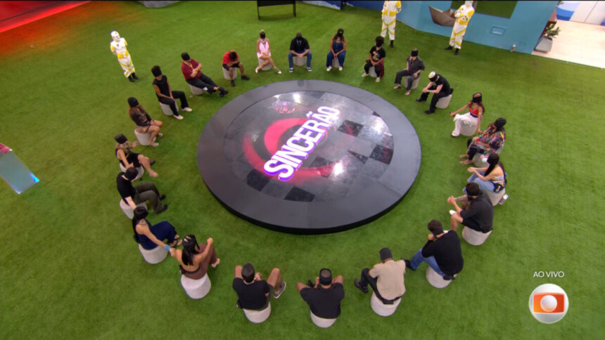 Participantes vendados em uma roda com um telão redondo escrito Sincerão do BBB 26