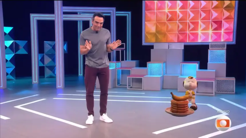 Tadeu Schmidt imitando os trejeitos de Gabriel no centro do cenário do BBB 26