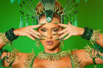 Virginia de roupa verde com as unhas de gel também verde e assessórios do carnaval 2026