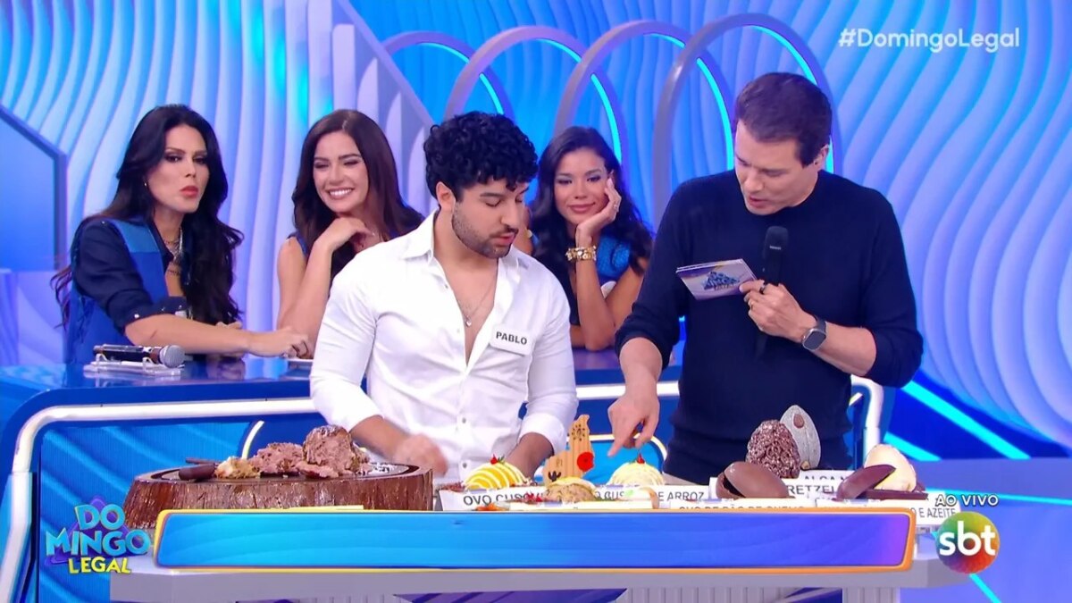 Celso Portiolli olha para mesa com ovos diferentes de Páscoa