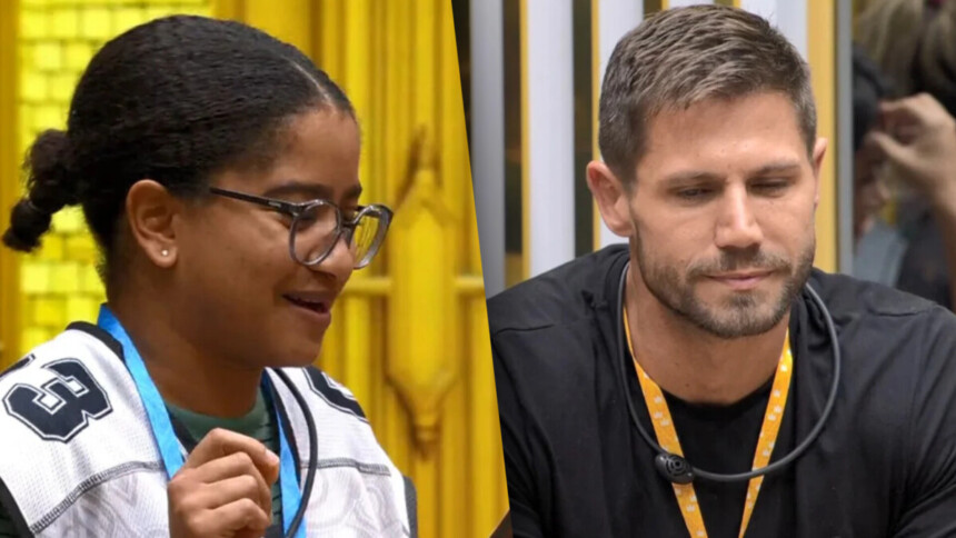 Milena divide tela com Jonas na sala do BBB 26. Ela sorrir e o coloca no Monstro, enquanto ele olha pra baixo