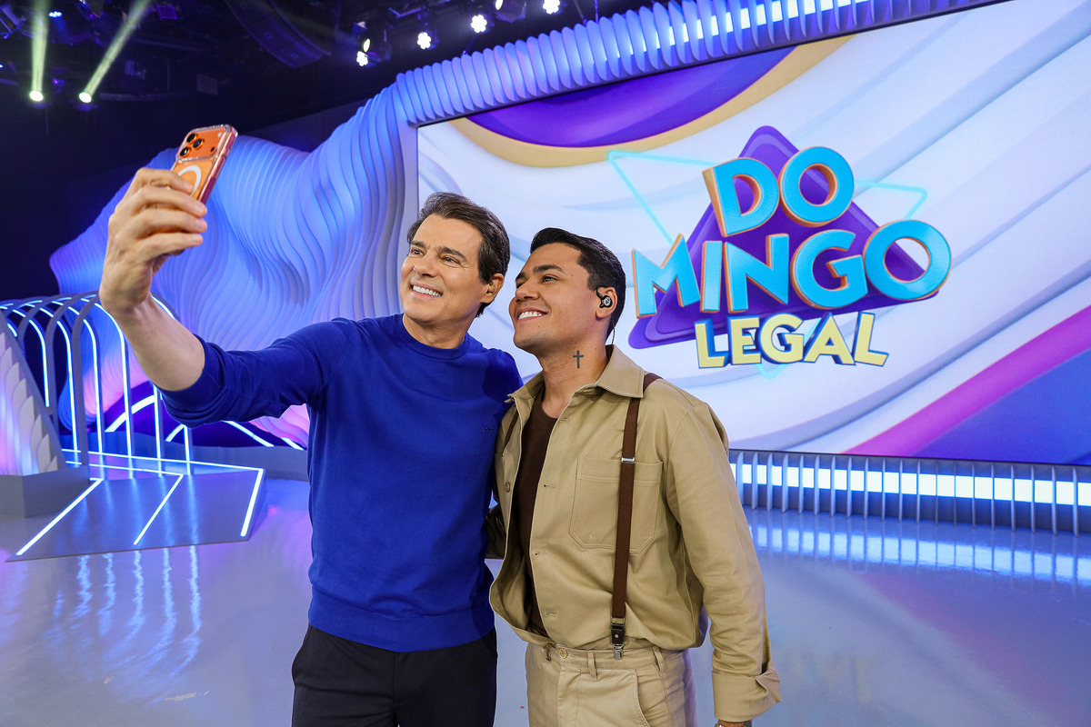 Celso Portiolli e Felipe Araújo posam em selfie no palco do Domingo Legal
