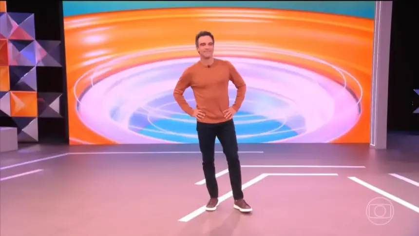 Tadeu Schmidt em pé no centro do cenário do BBB 26