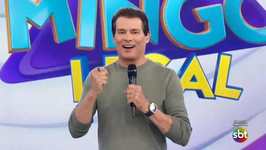 Celso Portiolli sorrindo no palco do Domingo Legal no SBT